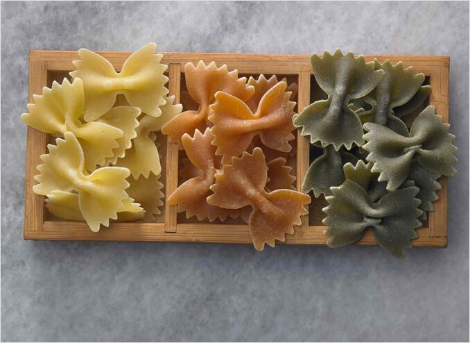 three colours of farfalle on timber plate farfalle pasta